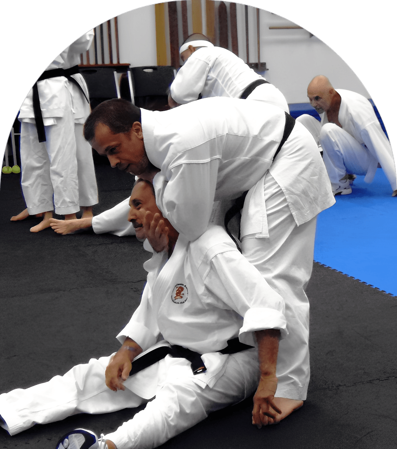 Students in karate uniforms on mat
