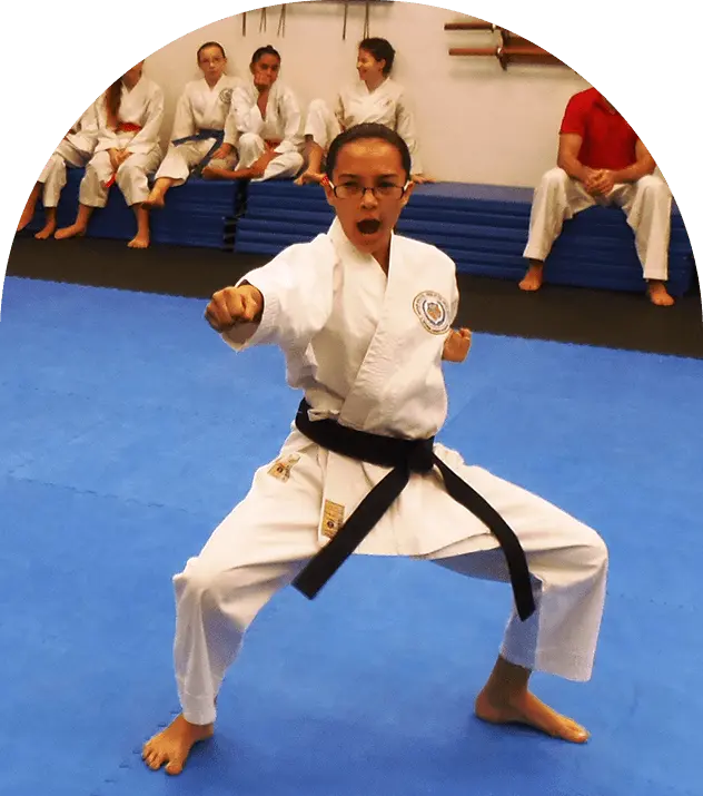Spectacled black-belt shouting in deep stance