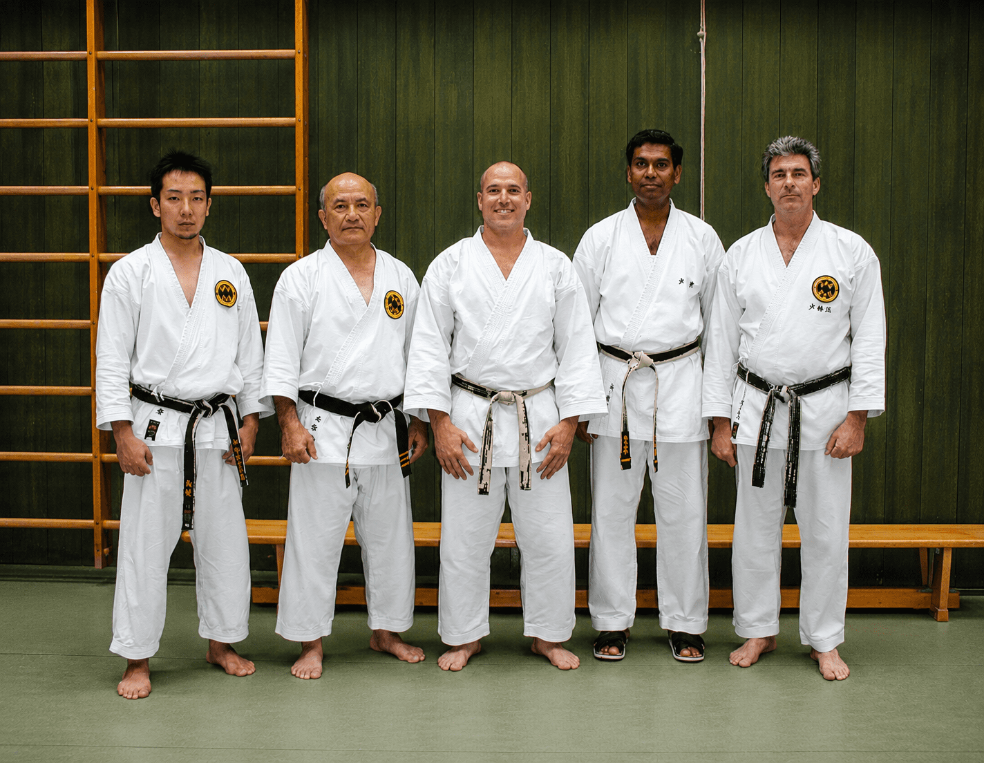 Five black-belt martial artists lined up