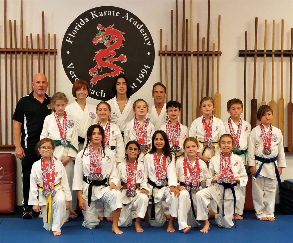 Florida Karate Academy children and instructors posing together with medals after a karate competition.