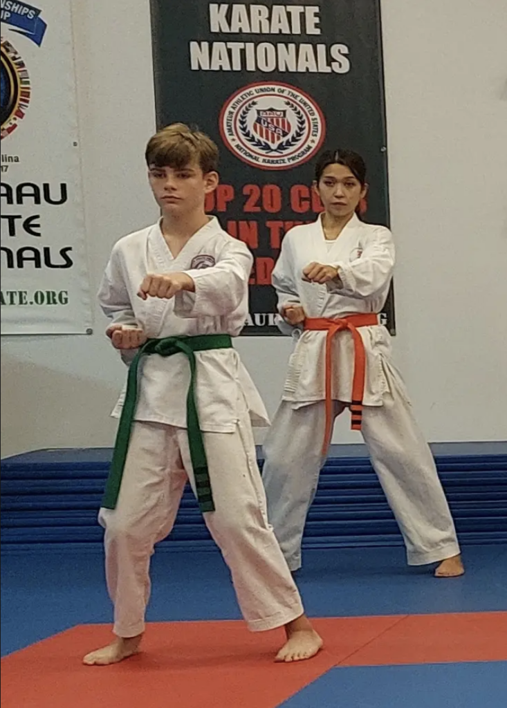 Two young karate students demonstrating karate techniques at a national competition