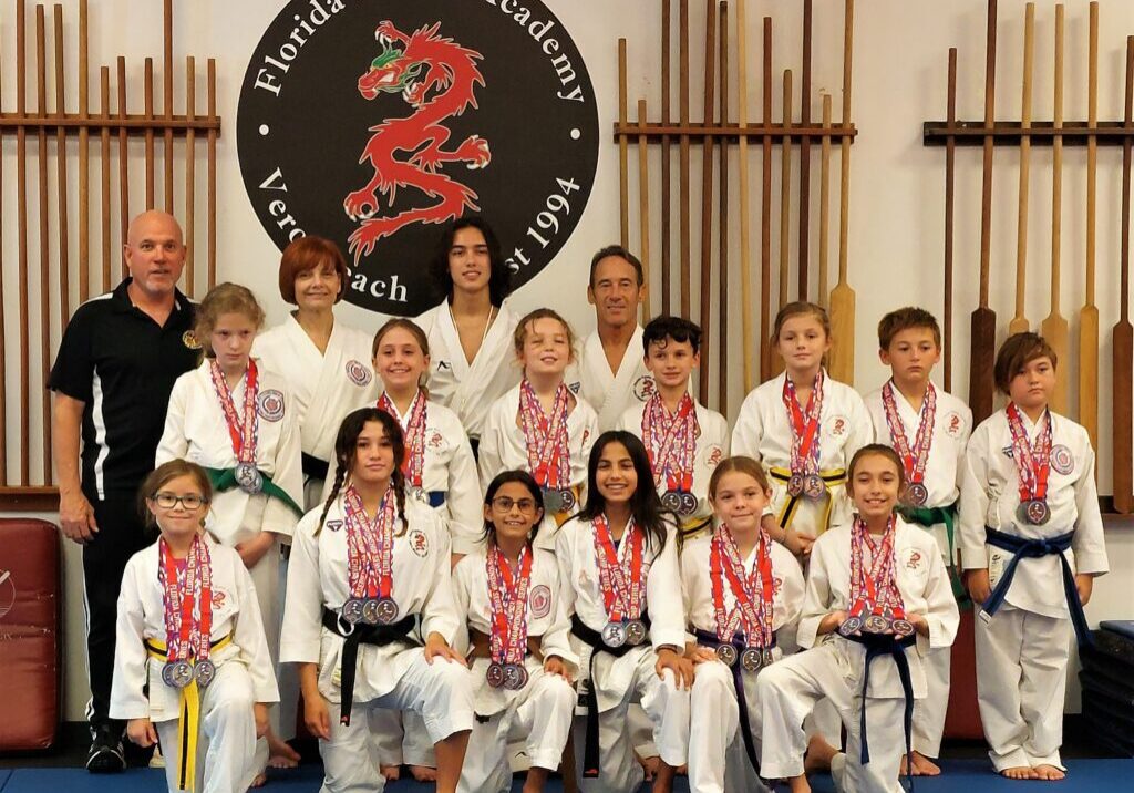 Florida Karate Academy children and instructors posing together with medals after a karate competition.
